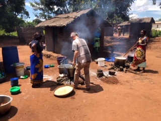 Cooking food for a community training event, paid for by Links International.