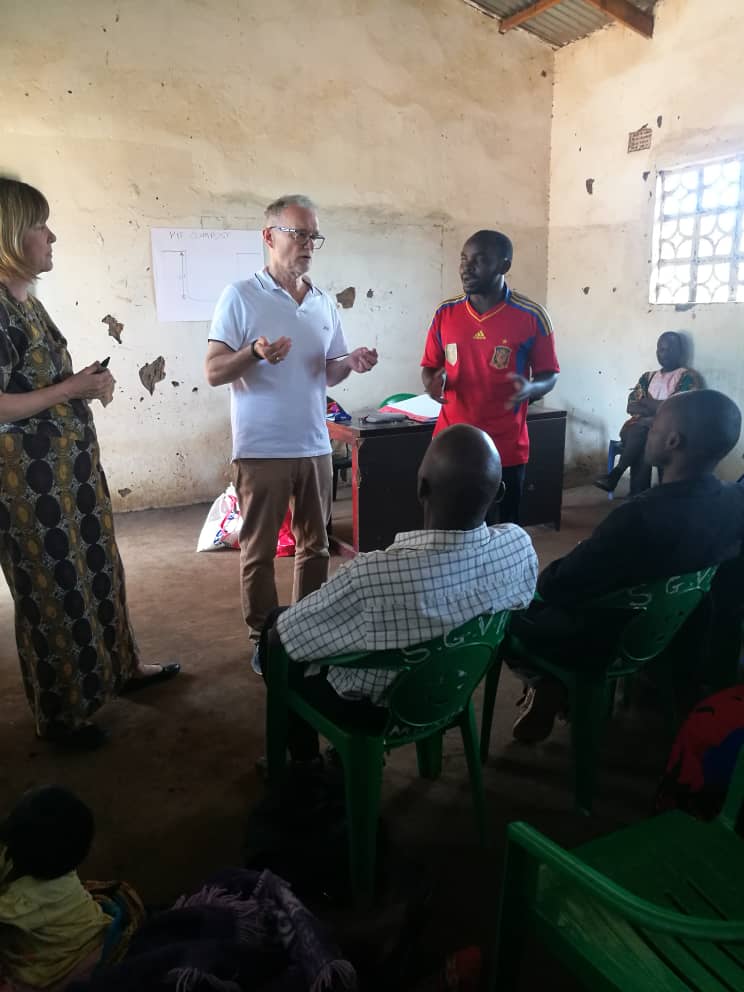 Caroline and husband Andy training a new Microenterprise group in central Malawi and viewing pig-rearing project, where pigs are donated for breeding as food and income source.